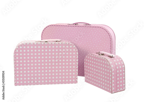 Photo: stack of three suitcases, pink with white dots , isolated on whi stack of three suitcases, pink with white dots , isolated on whi