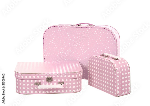 Photo: stack of three suitcases, pink with white dots , isolated on whi stack of three suitcases, pink with white dots , isolated on whi