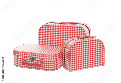 Photo: three vintage red and white suitcases, isolated three vintage red and white suitcases, isolated