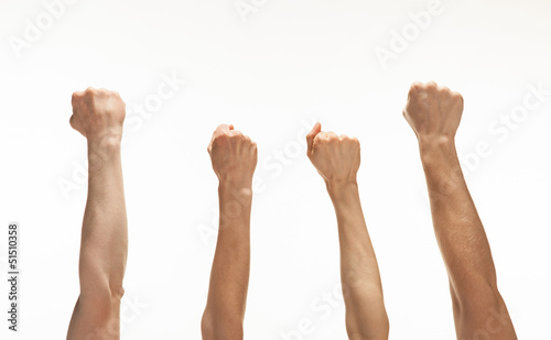 Photo: Four hands showing fists Four hands showing fists