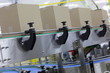 Photo: Cardboard boxes on conveyor belt in factory Cardboard boxes on conveyor belt in factory