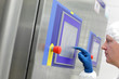 technician in  blue gloves touching screen at control panel