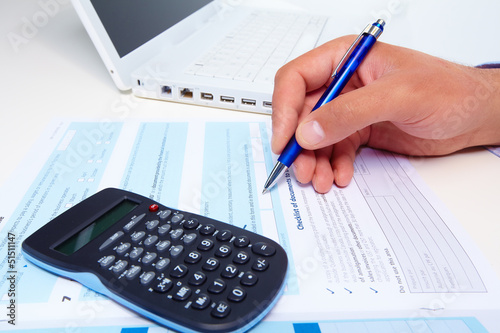 Photo: Businessman working with documents. Businessman working with documents.