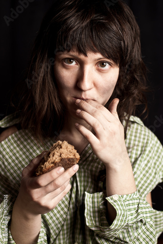 Photo: beggar woman eating bread beggar woman eating bread