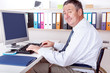 Foto: Man sitting in a wheelchair at the desk Man sitting in a wheelchair at the desk