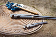 Photo: Hammer and wrench are on a manhole Hammer and wrench are on a manhole