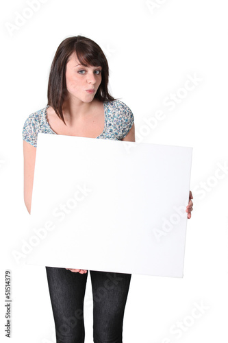 Photo: Young woman with a blank board Young woman with a blank board