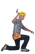 carpenter in profile using hammer