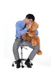 Businessman hugging teddy bear
