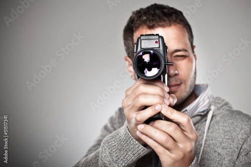 Photo: Man filming with a video camera. Man filming with a video camera.