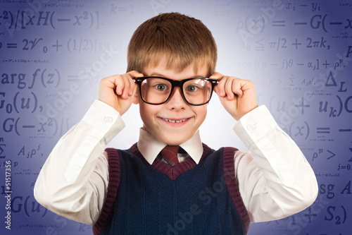 Photo: small kid prodigy on the formulas background small kid prodigy on the formulas background