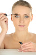 Woman applying mascara