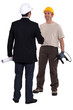 Architect and construction worker shaking hands