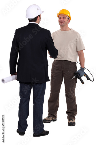 Photo: Architect and construction worker shaking hands Architect and construction worker shaking hands