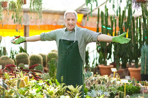 Photo: Employee working in a greenhouse Employee working in a greenhouse