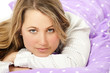 Photo: Young woman lying in bed Young woman lying in bed