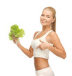 sporty woman with lettuce showing abs