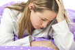 Young woman lying in bed