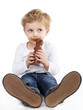 Cute little boy eating chocolate