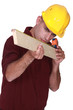 Carpenter measuring  wood