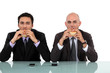 Photo: Two businessmen enjoying a burger. Two businessmen enjoying a burger.