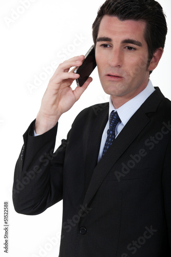 Photo: A businessman over the phone. A businessman over the phone.