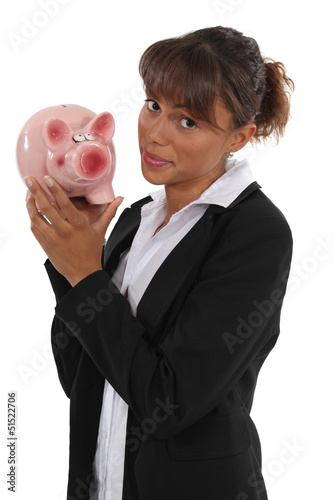 Photo: Businesswoman holding piggy-bank Businesswoman holding piggy-bank