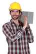 Foto: Builder with a concrete block Builder with a concrete block