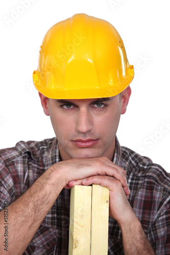 Photo: Construction worker with wood Construction worker with wood