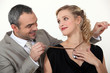 Man offering his wife a gift