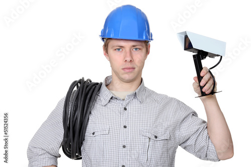 Photo: Electrician holding CCTV camera Electrician holding CCTV camera