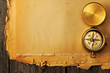 Antique brass compass over old background