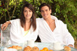 Photo: Young couple having breakfast outside Young couple having breakfast outside