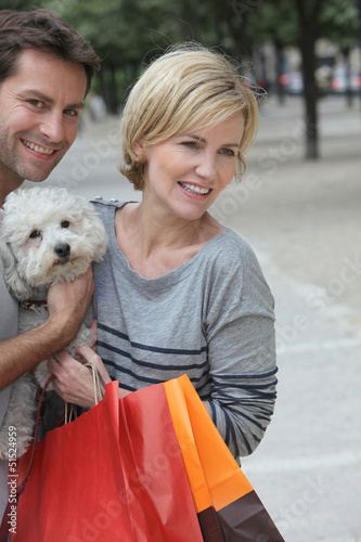 Photo: Couple out shopping with dog Couple out shopping with dog