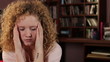 Young woman with headache, tracking shot