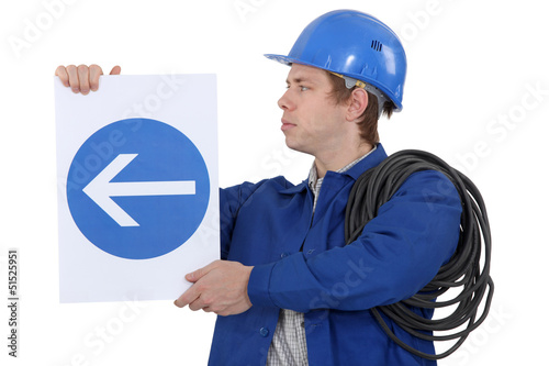 Photo: Electrician with a road sign Electrician with a road sign