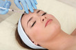 Young woman receiving plastic surgery injection