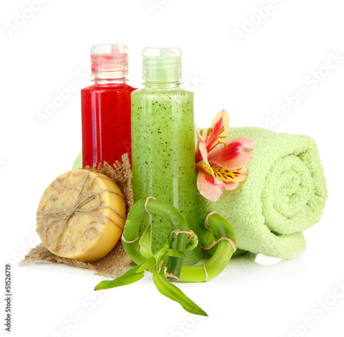 Photo: Bottles with scrub and hand-made soap, isolated on white Bottles with scrub and hand-made soap, isolated on white