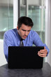Businessman concentrating fully on laptop screen