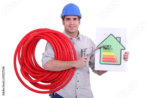 Photo: plumber holding a faucet and an energy consumption label plumber holding a faucet and an energy consumption label