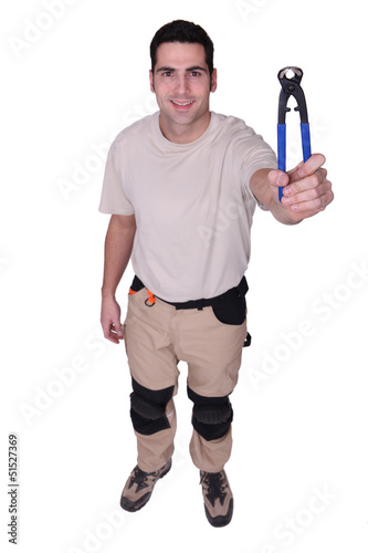Photo: Man showing pliers Man showing pliers