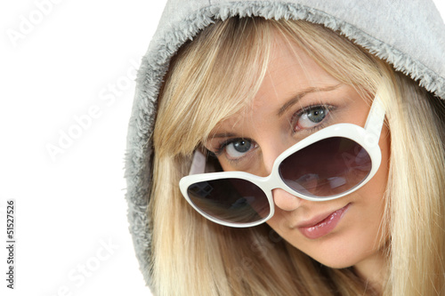 Photo: Blonde woman in large white sunglasses and a hooded fleece Blonde woman in large white sunglasses and a hooded fleece