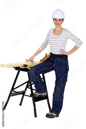 Photo: female carpenter and workbench isolated on white female carpenter and workbench isolated on white