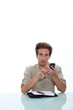 Photo: Man sitting a desk with a cellphone and personal organizer Man sitting a desk with a cellphone and personal organizer