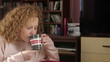 Young woman drinking coffee, tracking shot