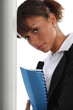 Photo: A cute black businesswoman holding a file. A cute black businesswoman holding a file.