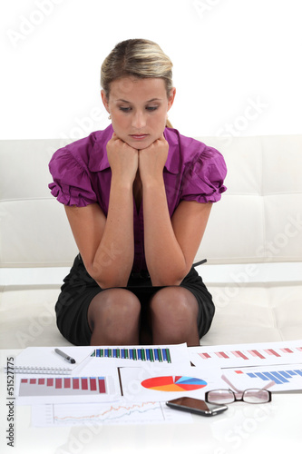 Photo: businesswoman examining graphic charts businesswoman examining graphic charts