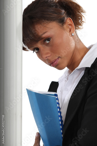 Photo: A cute black businesswoman holding a file. A cute black businesswoman holding a file.