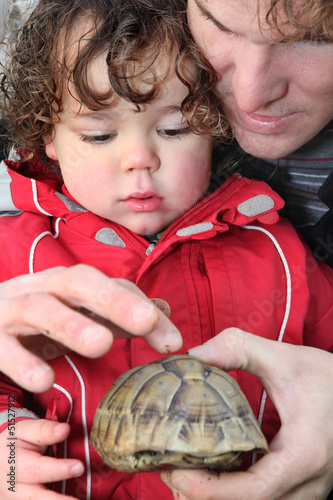 Photo: Father and son with a tortoise Father and son with a tortoise