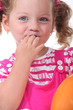 Girl with fingers in mouth